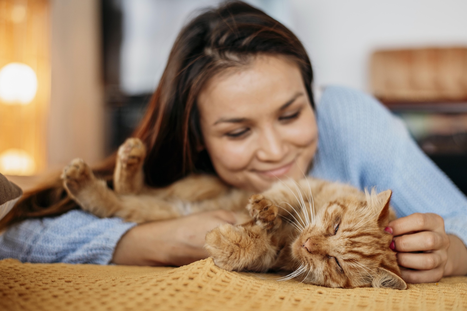 Mujer abrazando a su gato naranja